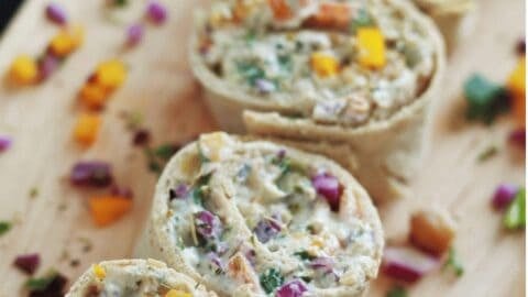 This pinwheels recipe is the perfect finger food for your next gathering. Packed with rainbow colored veggies and chickpeas, not only are they nutritious but also super easy to make. Serve them up for the holidays, BBQ parties, game night, grilling party, birthday party or simply just pack them for lunch, they are always a hit. Try them yourself! #pinwheels #pinwheelsrecipe #pinwheelssandwich #hwotomakepinwheels #easypinwheelsrecipe #vegetarianpinwheels #rainbowpinwheels #tortillarollups #rainbowvegetables #chickpearecipe