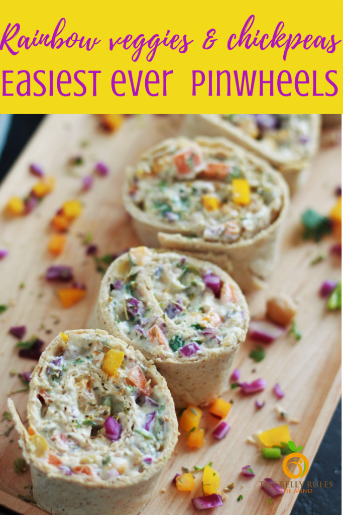 This pinwheels recipe is the perfect finger food for your next gathering. Packed with rainbow colored veggies and chickpeas, not only are they nutritious but also super easy to make. Serve them up for the holidays, BBQ parties, game night, grilling party, birthday party or simply just pack them for lunch, they are always a hit. Try them yourself! #pinwheels #pinwheelsrecipe #pinwheelssandwich #hwotomakepinwheels #easypinwheelsrecipe #vegetarianpinwheels #rainbowpinwheels #tortillarollups #rainbowvegetables #chickpearecipe