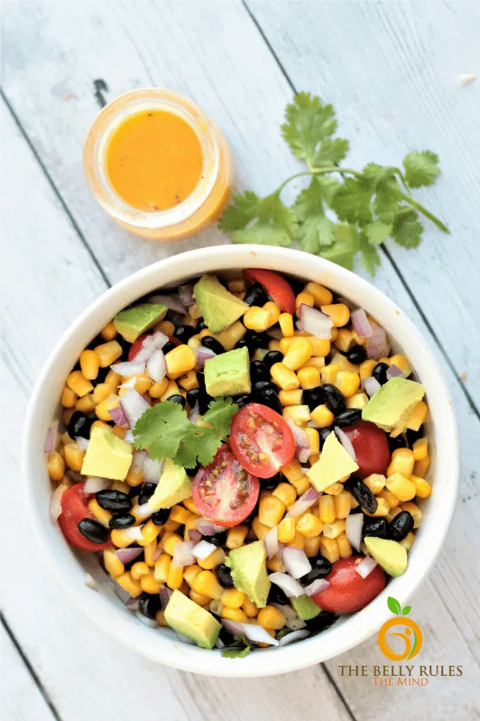 black bean and corn salad in a bowl and goldenberry dressing