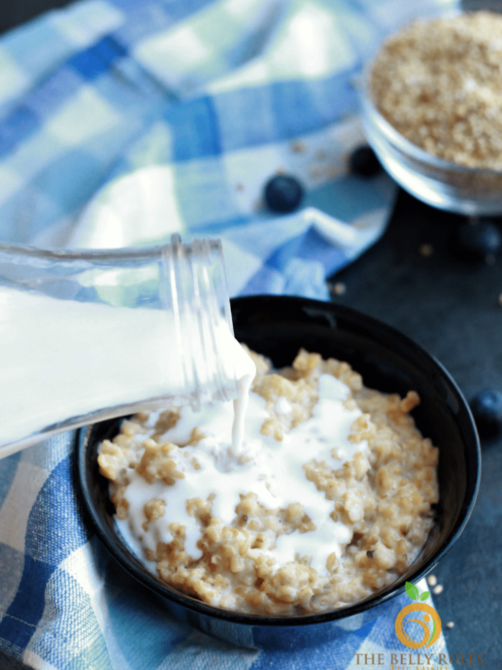 pouring milk in steel cut oats cooked in Instant Pot