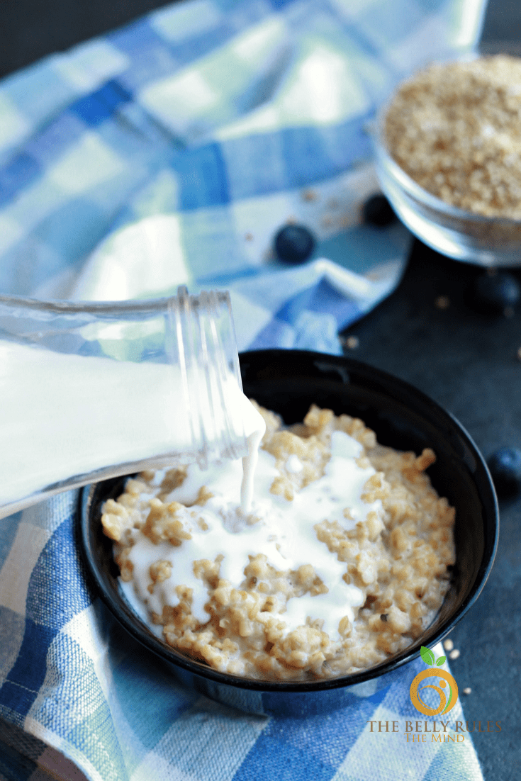pouring milk in steel cut oats cooked in Instant Pot