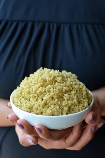 Perfectly cooked quinoa in a white bowl, ready to serve.