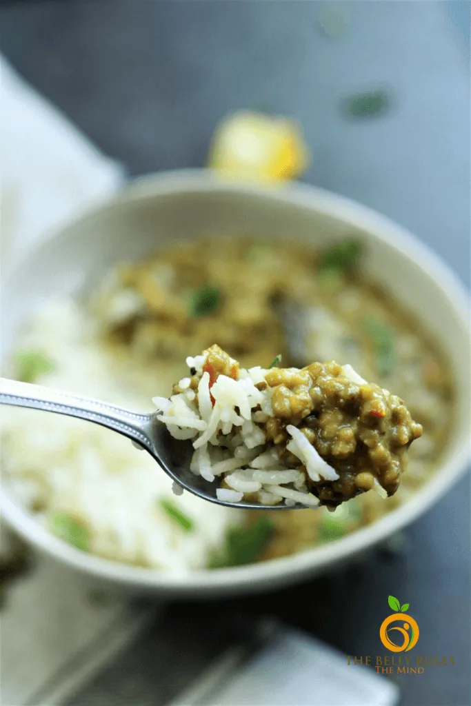 green moong dal and rice on a spoon