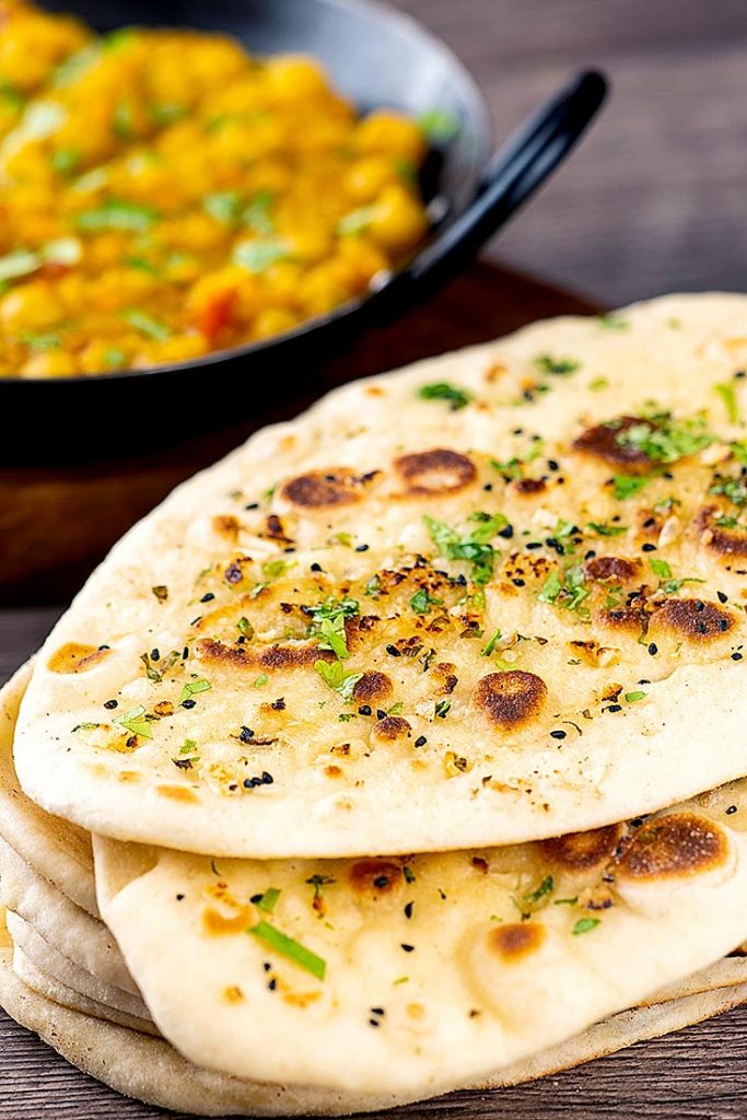 pile of garlic naan with curry