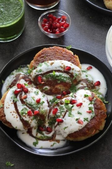 Delhi Aloo Tikki chaat plated on a black plate