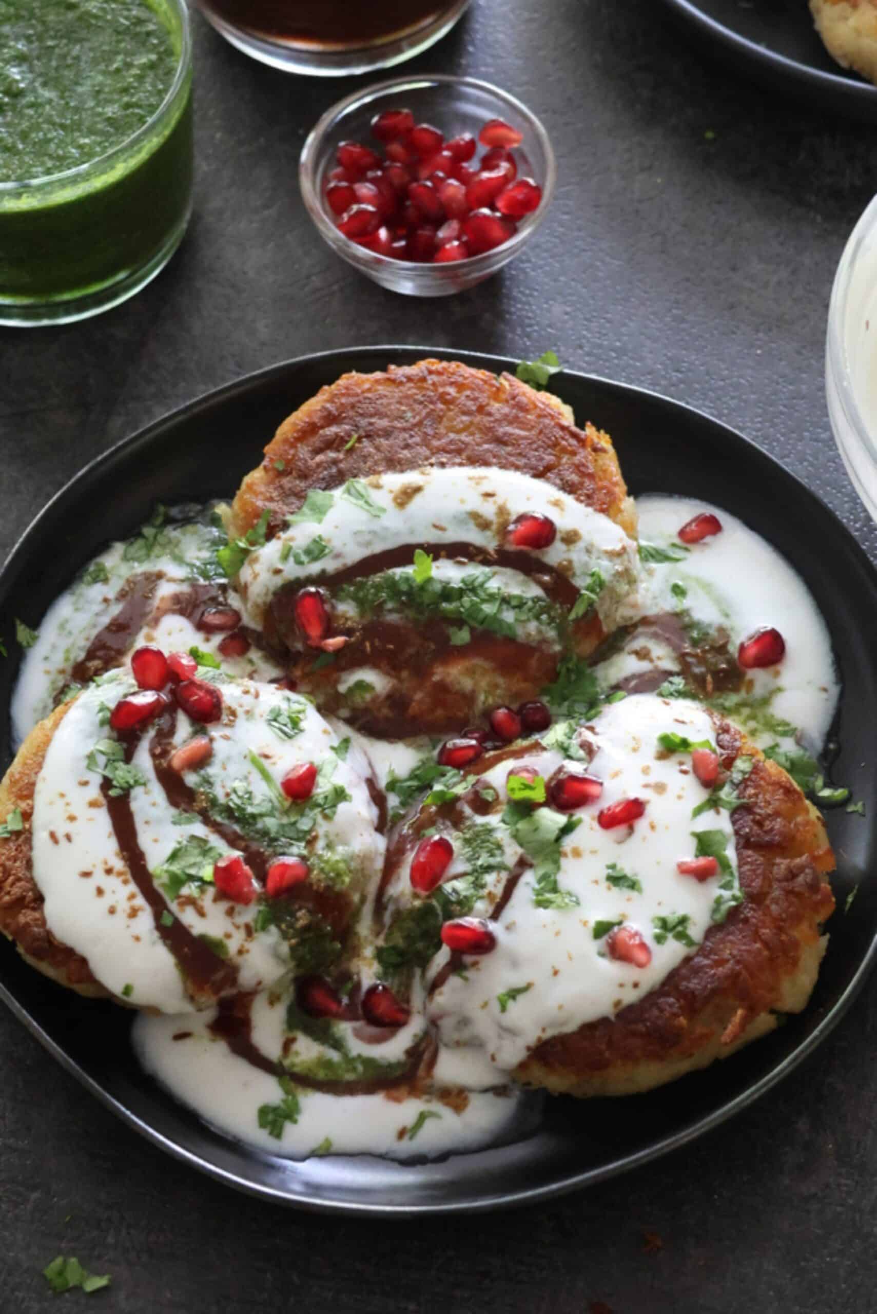 Delhi Aloo Tikki chaat plated on a black plate