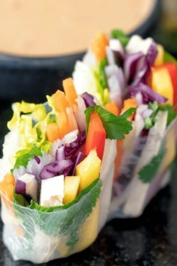 Delicious fresh Vietnamese spring rolls filled with colorful vegetables and herbs, perfect for a hea.