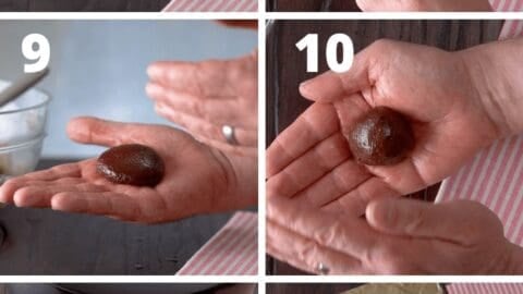 Hand holding chocolate truffle with a smooth surface.