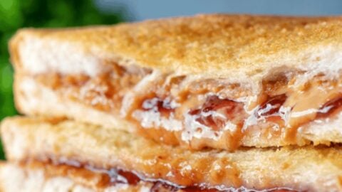Delicious air fryer peanut butter and jelly sandwich with crispy bread and gooey filling.