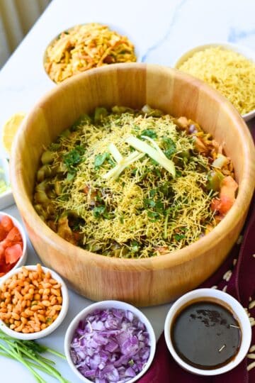 Delicious Bhel Puri with crunchy sev, fresh vegetables, and tangy tamarind sauce. Perfect for snack.