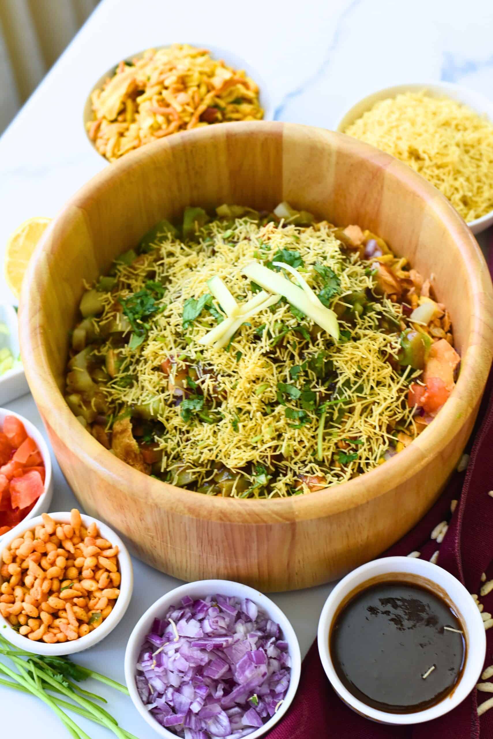 Delicious Bhel Puri with crunchy sev, fresh vegetables, and tangy tamarind sauce. Perfect for snack.
