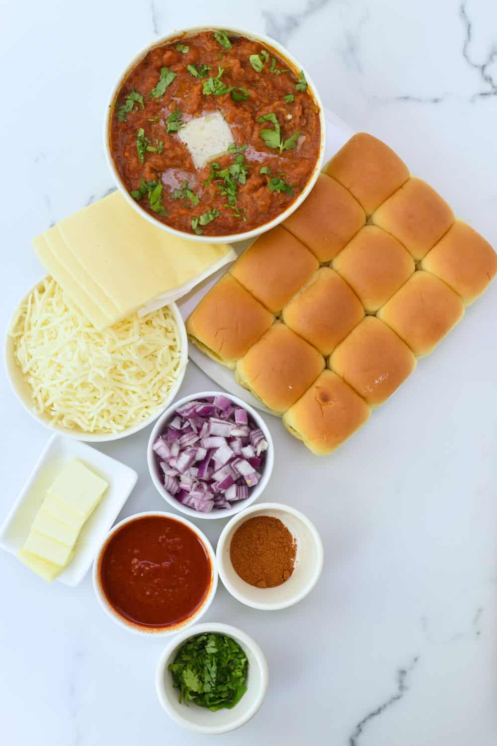 Delicious Pav Bhaji sliders served with spicy curry, cheese, and fresh toppings, perfect for a flavo.