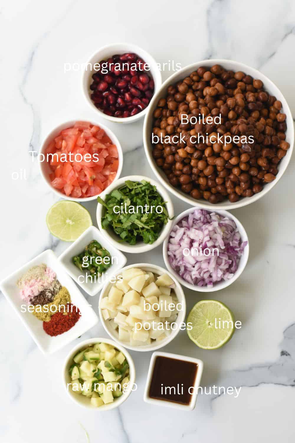 Vibrant kala chana chaat ingredients with tomatoes, onions, cilantro, and spices for nutritious snac.