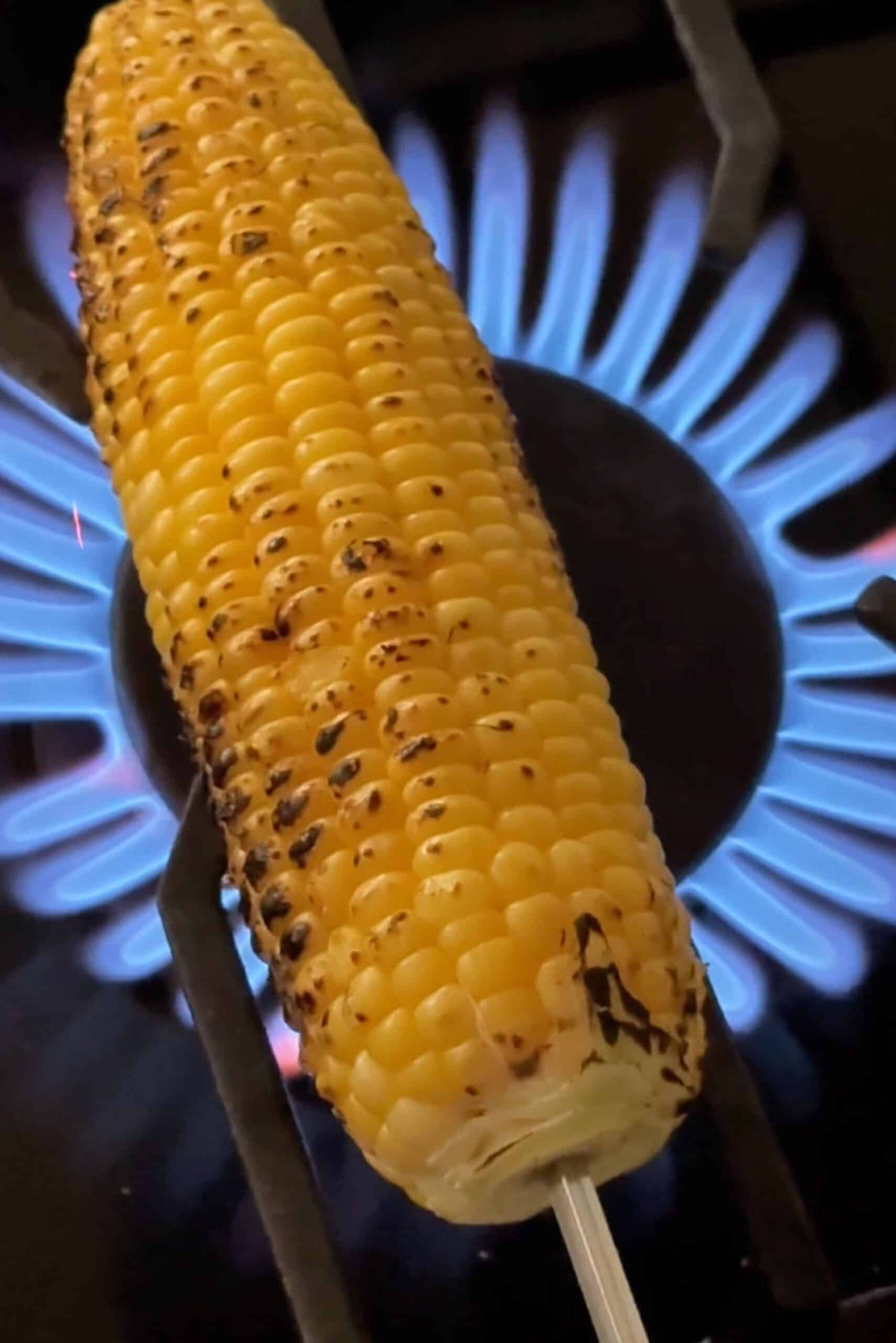 Delicious Indian street-style corn on the cob cooked on a gas stove flame. Perfect for flavorful sna.
