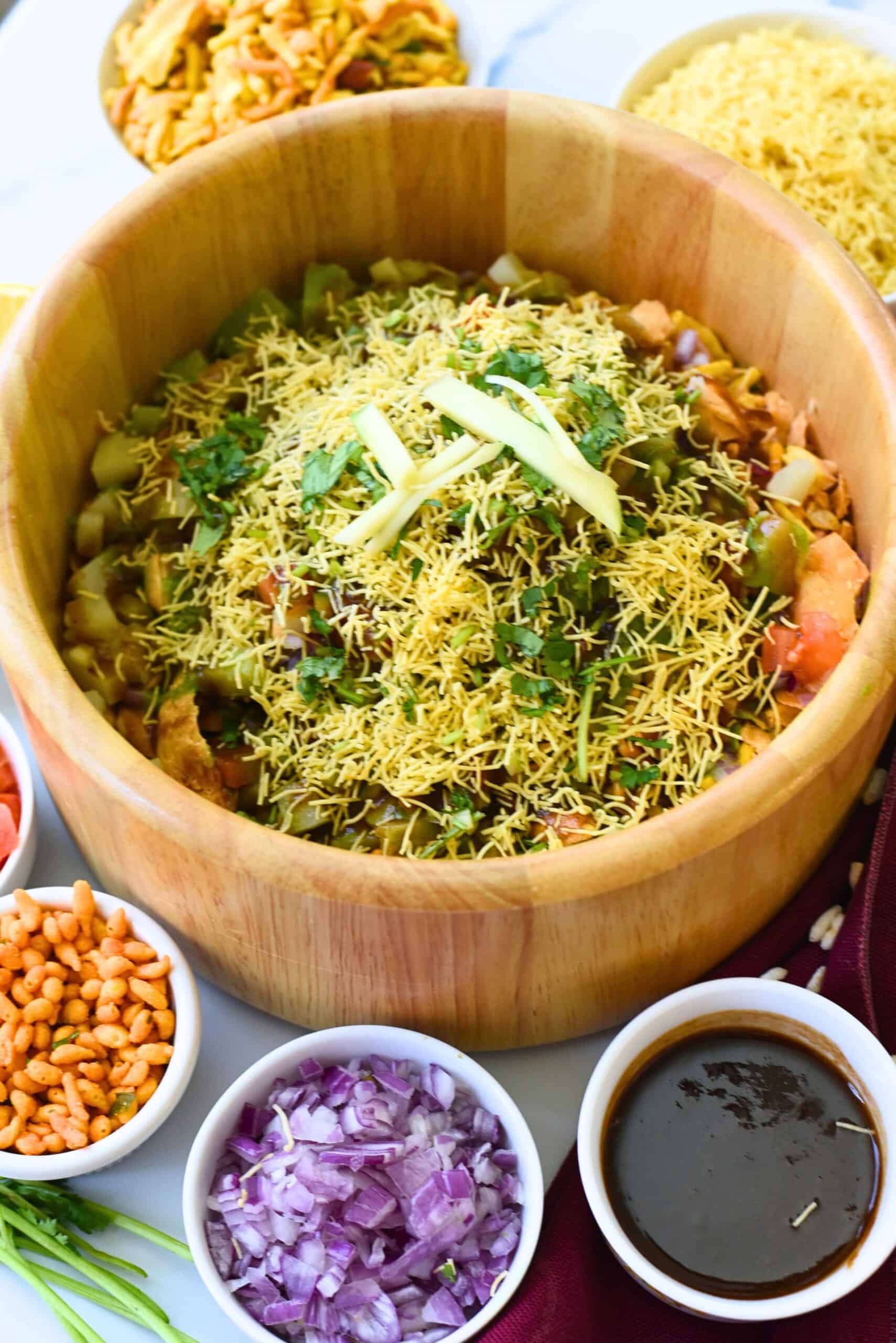 Traditional Bhel Puri served in a wooden bowl with chutneys and toppings.