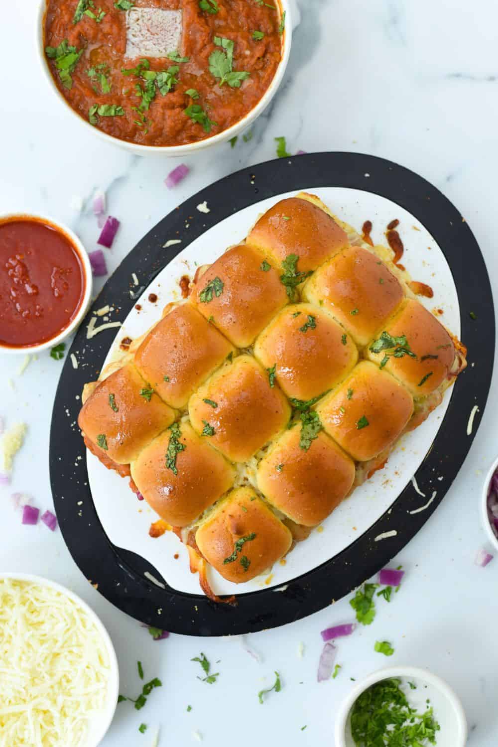 Vegan Pav Bhaji sliders served with spicy tomato chutney and fresh herbs. Perfect for snack or party.