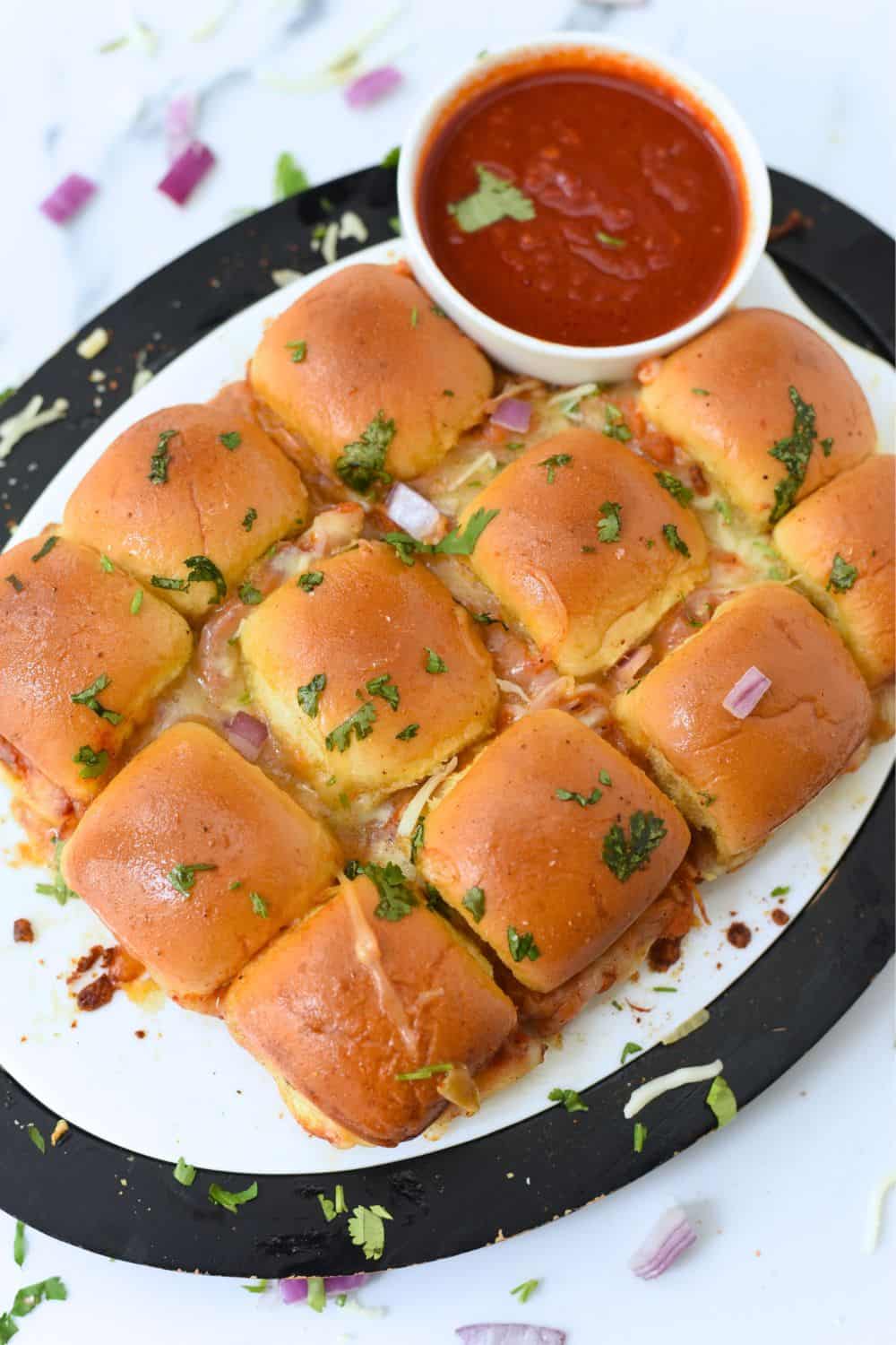 Delicious Pav Bhaji sliders with spicy tomato chutney and fresh herbs.