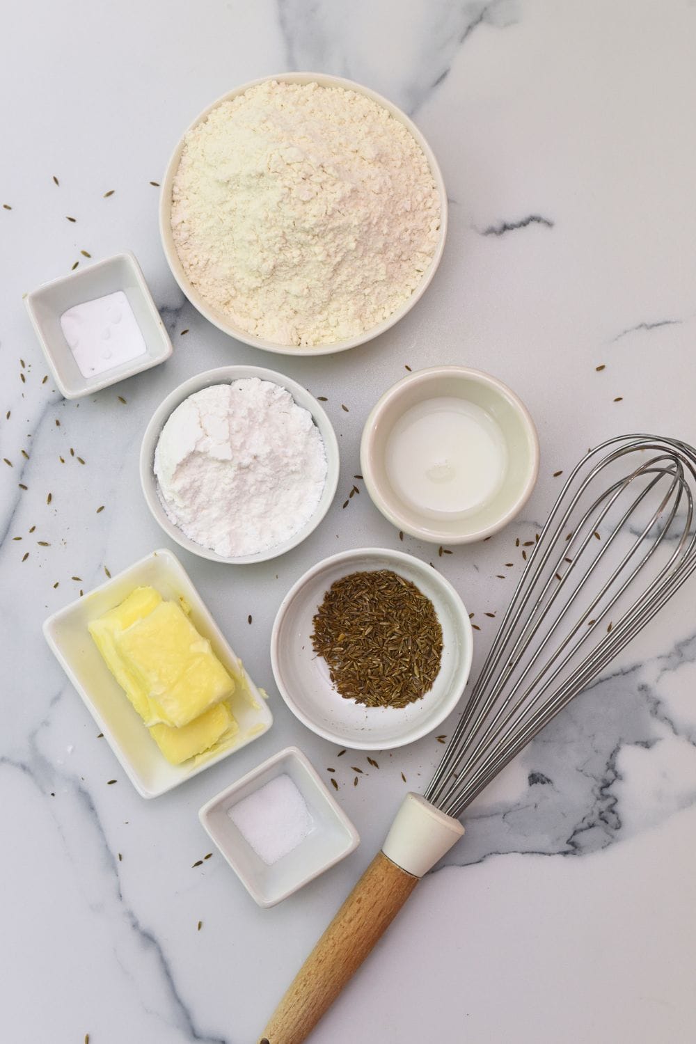 Jeera biscuit ingredients including flour, butter, cumin seeds, and salt.