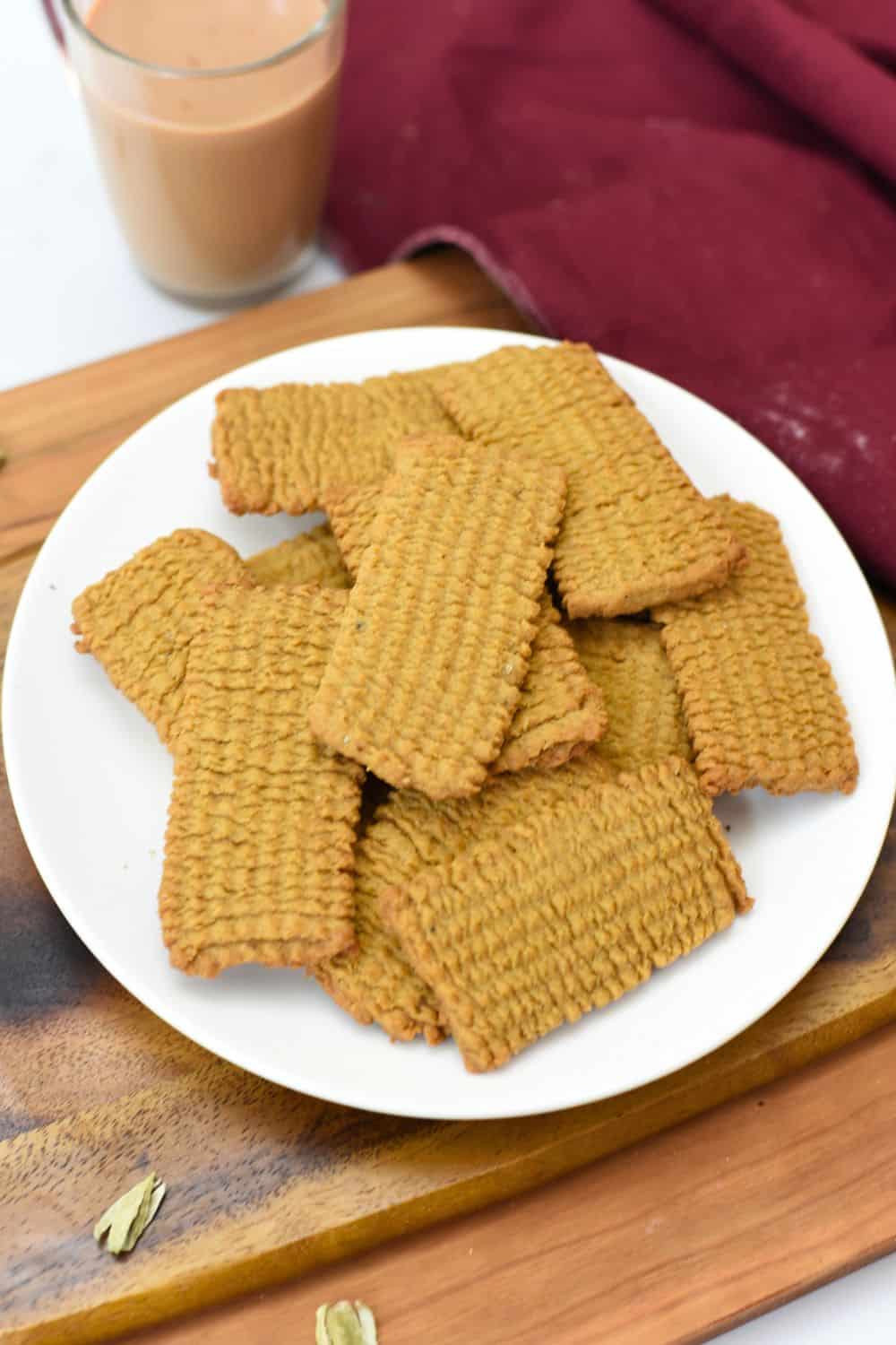 Crunchy, golden Punjabi Atta Biscuits served on a white plate.
